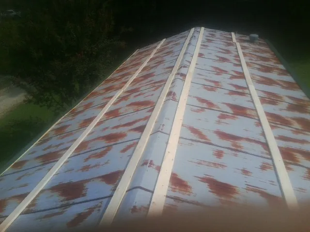 Rusted metal roof panels with new wood purlins before replacement — Storm Damage Roof Repair in Severn by Roofing Brothers
