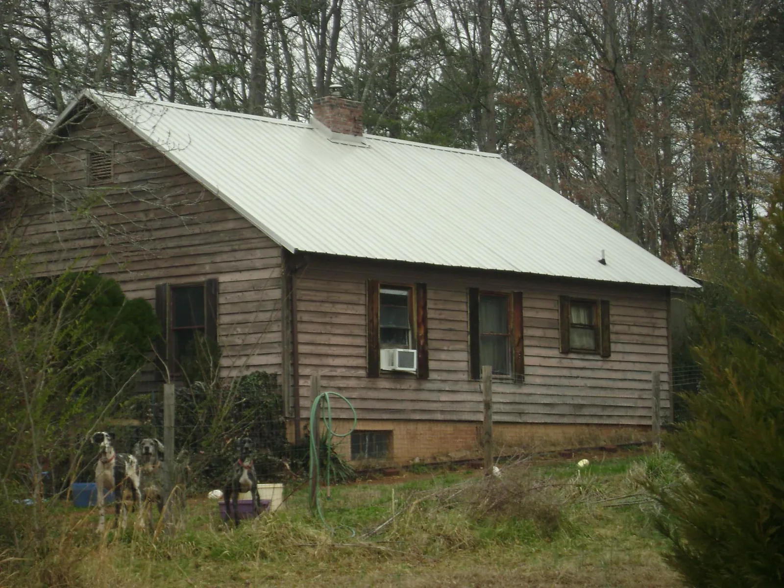 White metal roof on an old wood sided farmhouse, from a Metal Roof Installation job in Severn