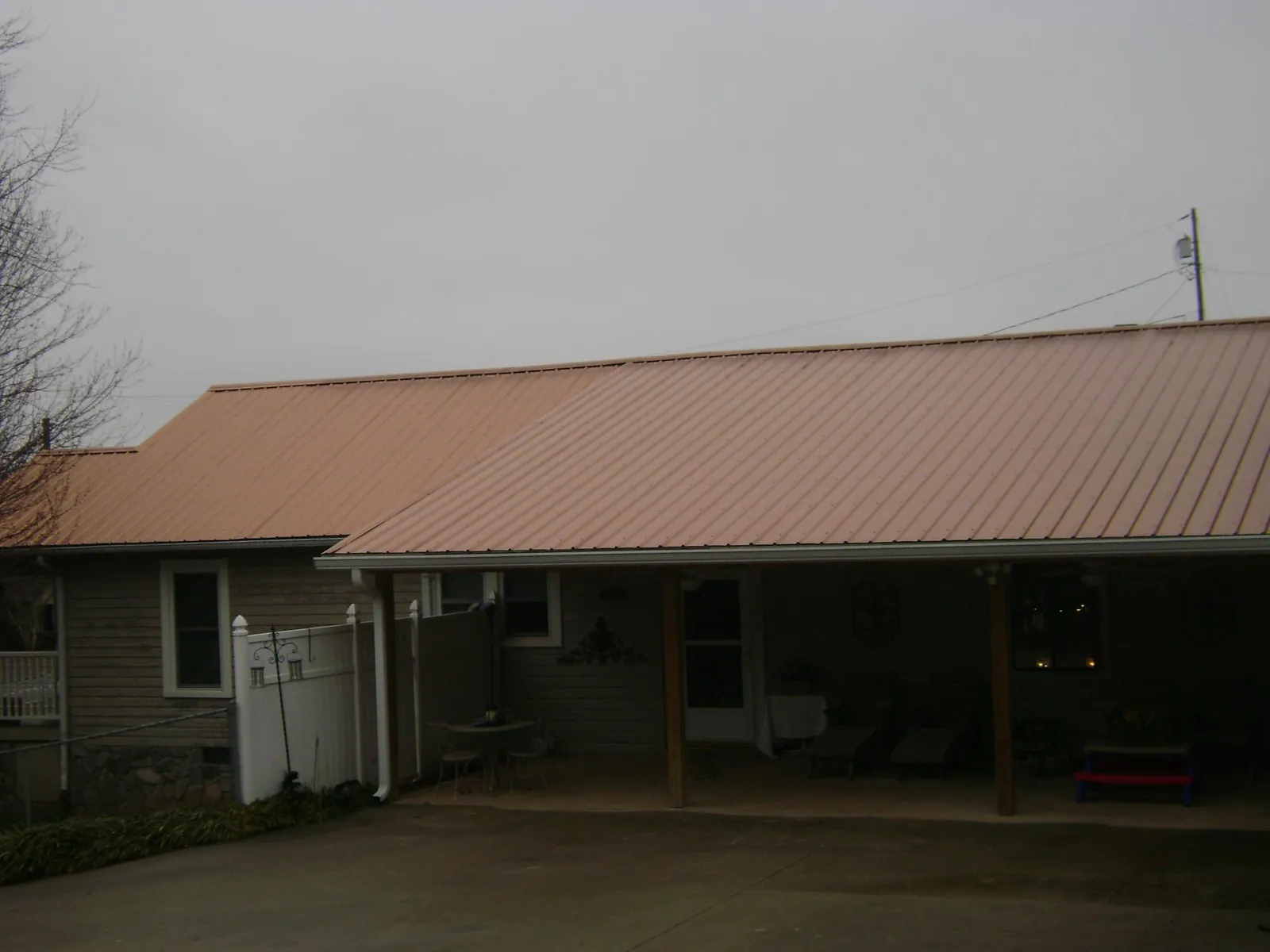 Copper toned metal roof over a wide covered patio in Severn